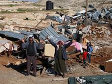 Palestinian Bedouin men react amidst the rubble of a structure after it was razed by the Israeli army in the West Bank village of Zayem, near Jerusalem November 29, 2011 (AFP Photo / Ahmad Gharabli)